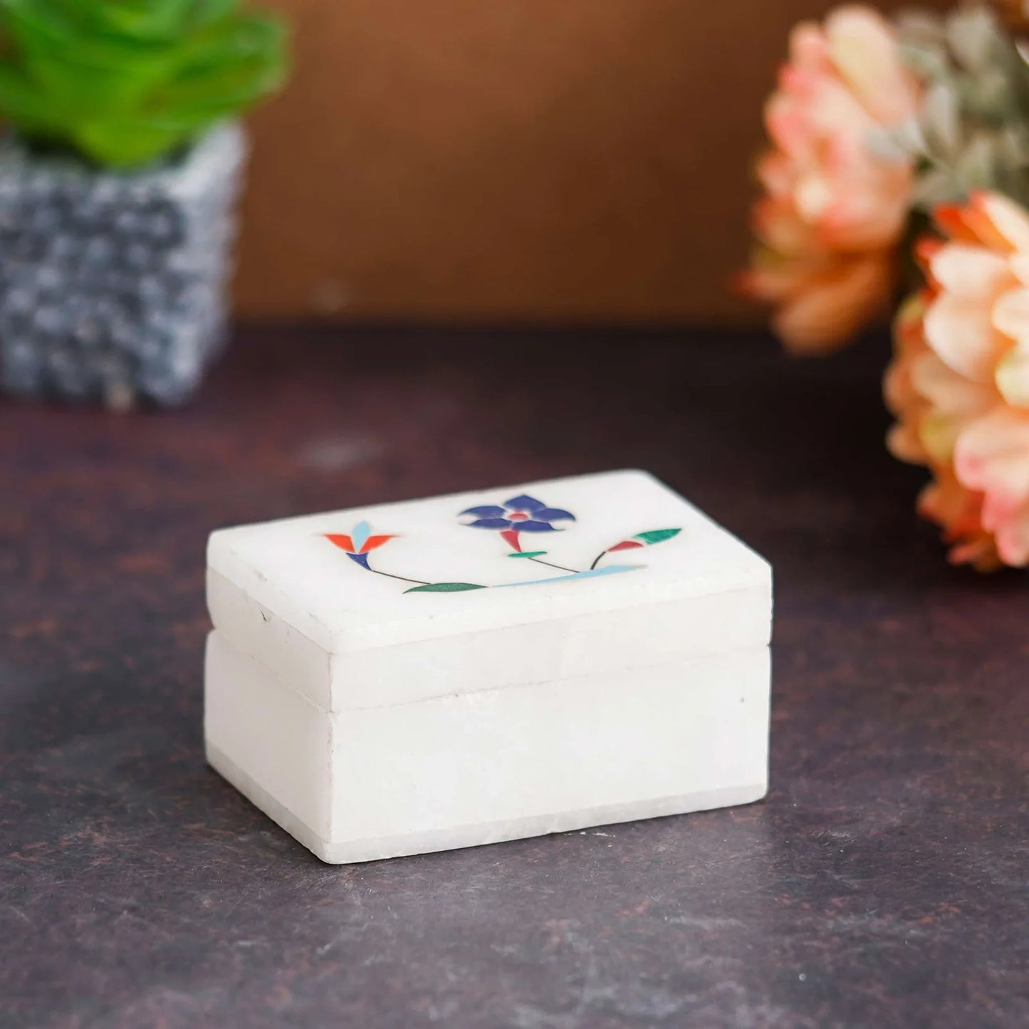 Handcrafted white marble inlay box with floral design held by a woman