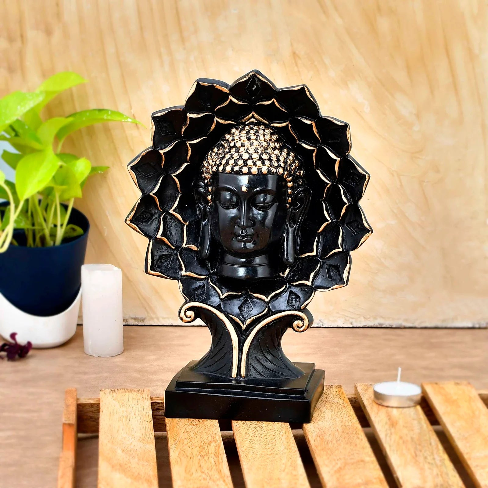 Elegant black and gold Buddha face sculpture with lotus petal frame